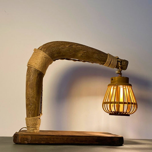 Plowman’s Lantern lit on a farmhouse desk, warm dappled glow from rattan shade