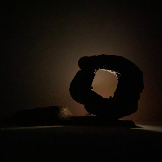 Altar of Time & Cloud with symbolic backlit glow from hollow cavity, dark meditation room