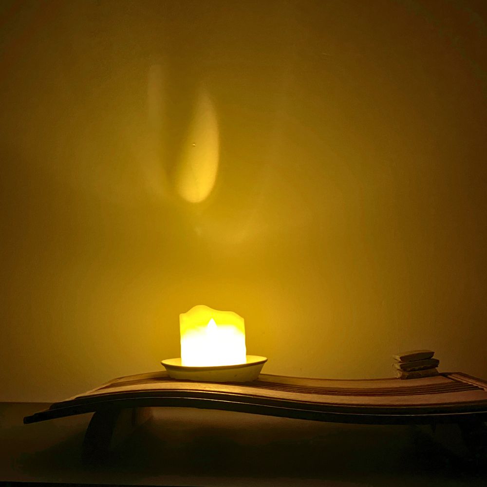 Chronometer of Light illuminated on a wooden desk, warm glow highlighting the beam and bowl