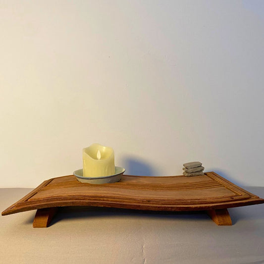 Chronometer of Light illuminated on a wooden desk, warm glow highlighting the beam and bowl