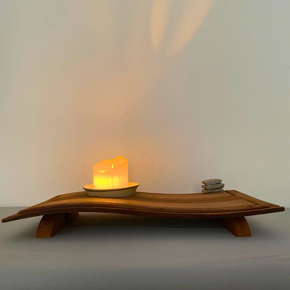 Chronometer of Light illuminated on a wooden desk, warm glow highlighting the beam and bowl